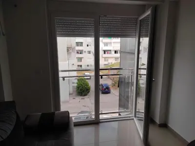 a room with a window with a view of a parking lot at Apartman Centar Bar in Bar
