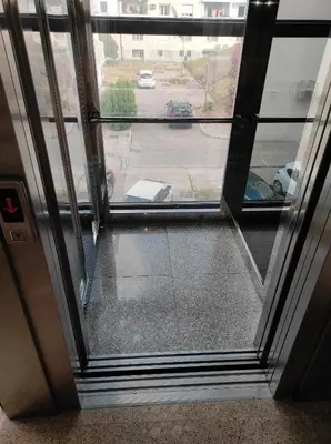 a glass door with a view of a parking lot at Apartman Centar Bar in Bar