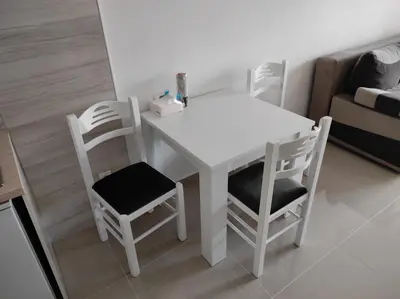 a white table and chairs in a living room at Apartman Centar Bar in Bar