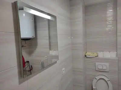 a bathroom with a toilet and a mirror at Apartman Centar Bar in Bar