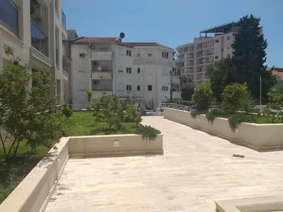 a walkway in the middle of a city with buildings at Apartment Joković in Budva