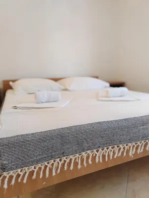 a bed with two towels on top of it at Vila Goga in Ulcinj