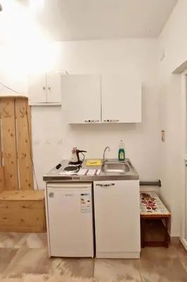 a small kitchen with a sink and a counter at Vila Goga in Ulcinj