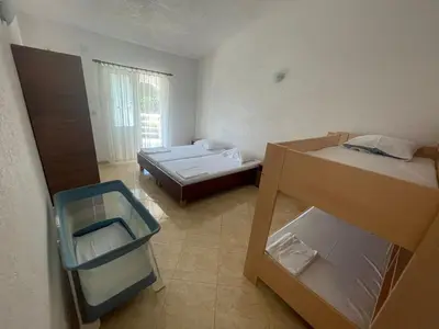 a small room with two beds and a window at Vila Goga in Ulcinj