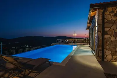 a swimming pool on the roof of a house at night at Vila katune 2022 in Ulcinj