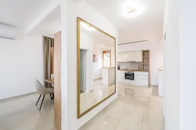 a living room with a large mirror on the wall at Vila katune 2022 in Ulcinj