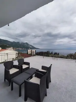 a group of chairs and tables on a patio at Apartmani Bellami in Becici