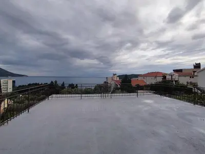 a large patio with a view of the water at Apartmani Bellami in Becici