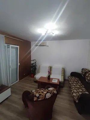 a living room with a couch and a bed at Apartmani Bellami in Becici