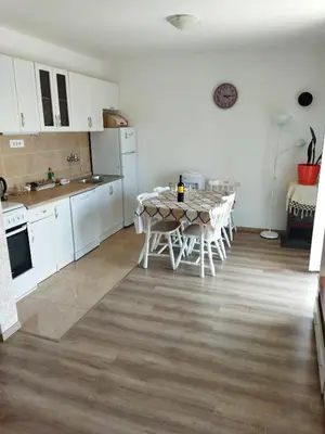 a kitchen with a table and chairs in a room at Apartmani Bellami in Becici