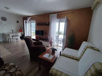 a living room with a couch and a table at Apartmani Bellami in Becici