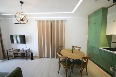 a kitchen and dining room with a table and chairs at Luxury Mare apartment in Bar