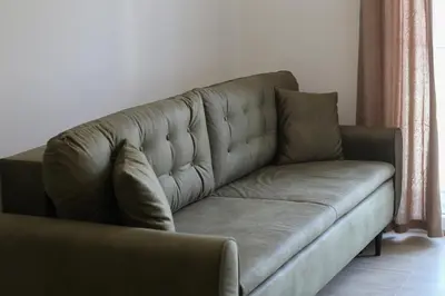 a brown leather couch in a living room at Luxury Mare apartment in Bar
