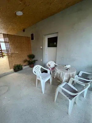 a patio with a table and chairs and a table and chairs at Apartmani LALA 2 Canj in Čanj