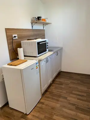 a kitchen with a microwave and a refrigerator at Apartmani LALA 2 Canj in Čanj
