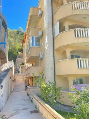 an apartment building with stairs leading up to it at Seashell Hideaway Apartment in Pržno