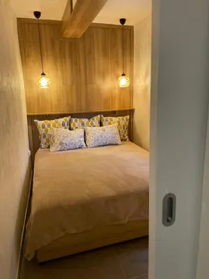 a bedroom with a bed with two pillows at Seashell Hideaway Apartment in Pržno