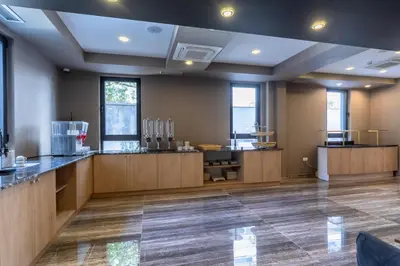 a large kitchen with wooden counters and windows at N Hotel in Sutomore