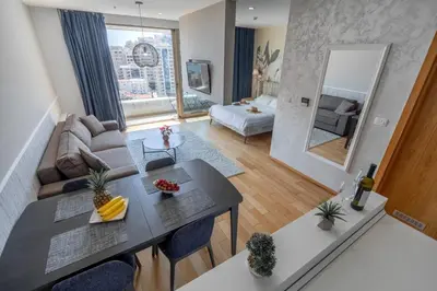 a living room with a table and a couch at City Apartments 2 in Budva