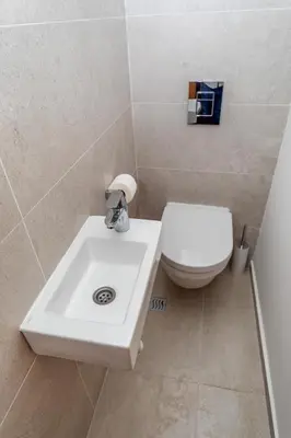 a bathroom with a white sink and a toilet at City Apartments 2 in Budva