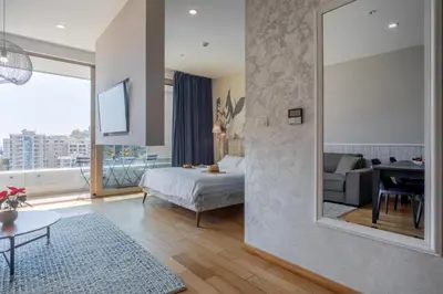 a bedroom with a bed and a mirror in a room at City Apartments 2 in Budva