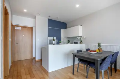 a kitchen and dining room with a table and chairs at City Apartments 2 in Budva
