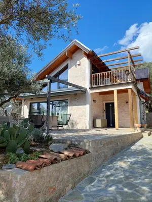 a house with a roof that has a porch at Villa Butterfly Valdanos in Ulcinj
