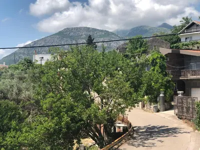 a street in a town with a mountain in the background at Апартаменты Jasmine in Bar