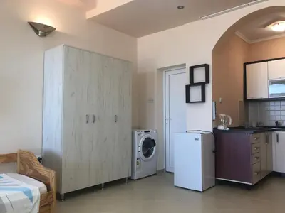 a kitchen with a refrigerator and a washing machine at Апартаменты Jasmine in Bar