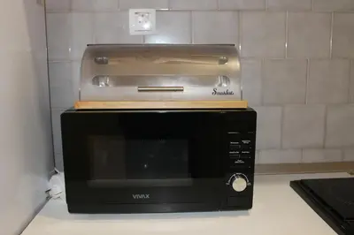 a toaster oven sitting on top of a microwave at Апартаменты Jasmine in Bar