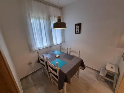 a dining room with a blue table and a window at Golden Fields Apartment near the Old Town in Kotor