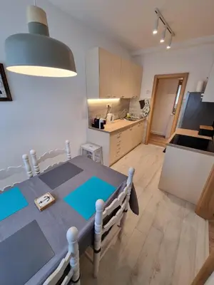 a kitchen and dining room with a table in a room at Golden Fields Apartment near the Old Town in Kotor