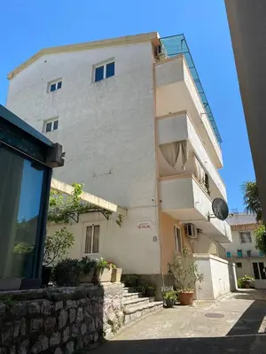 a tall building with a balcony on the side of it at Alina's apartment in Becici