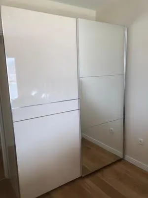 two white closets with glass doors in a room at SunshineLiving, Bar in Bar