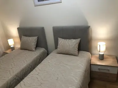 a bedroom with a bed and a night stand with two lamps at SunshineLiving, Bar in Bar