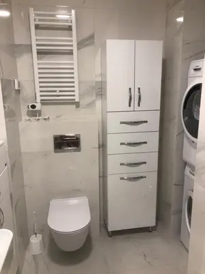 a bathroom with a toilet and a washing machine at SunshineLiving, Bar in Bar