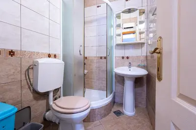 a bathroom with a toilet and a sink at Porta Volta Apartments in Becici