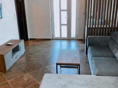 a living room with a couch and a coffee table at Zodea Apartments in Dobra Voda