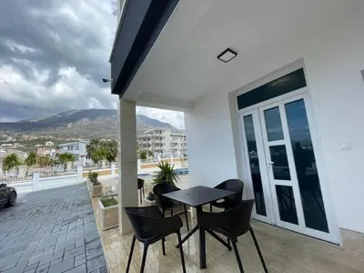 a patio with a table and chairs on a balcony at Zodea Apartments in Dobra Voda
