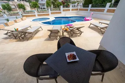 a table and chairs with a plate of fruit on it at Zodea Apartments in Dobra Voda