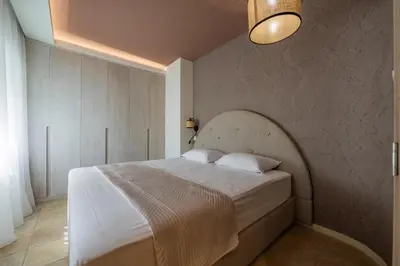 a bedroom with a large white bed in a room at Vila Gina in Bar