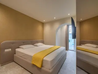 a bedroom with a large bed with a yellow blanket at Vila Gina in Bar