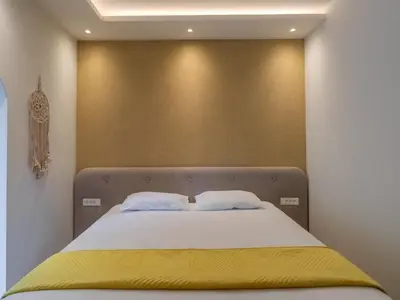 a bedroom with a bed with a yellow blanket on it at Vila Gina in Bar