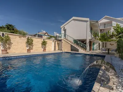 a swimming pool in front of a house at Vila Gina in Bar