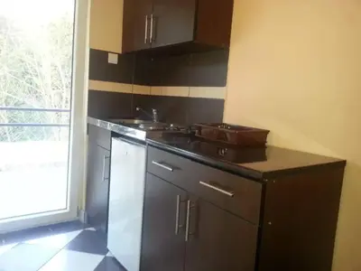 a kitchen with a counter and a sink and a window at Studios Milošev in Bar
