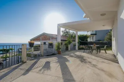 a patio with a table and chairs and a fence at Apartmani Vittoria in Bar