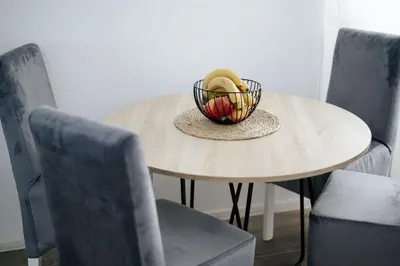 a table with a bowl on top of it with chairs at Apartmani Vittoria in Bar