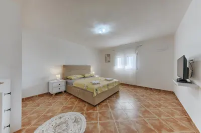 a bedroom with a bed and a television in it at Apartmani Vittoria in Bar