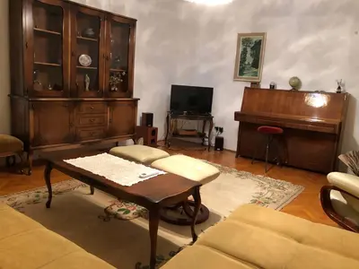 a living room with a coffee table and a piano at Apartment TARGET in Cetinje