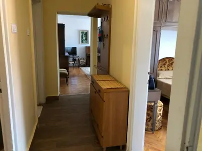 a hallway leading to a living room with a dresser at Apartment TARGET in Cetinje